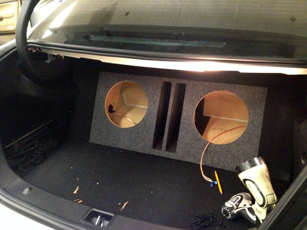 Close-up of JL Audio subwoofer mounted in custom enclosure in Mercedes C300 trunk Close-up of JL Audio subwoofer mounted in custom enclosure in Mercedes C300 trunk