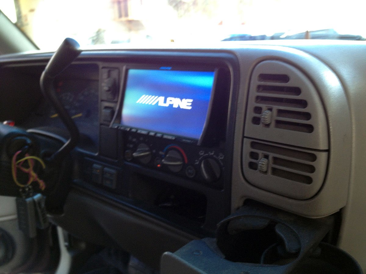 Alpine head unit installed in SUV dashboard during car audio system upgrade Alpine head unit installed in SUV dashboard during car audio system upgrade