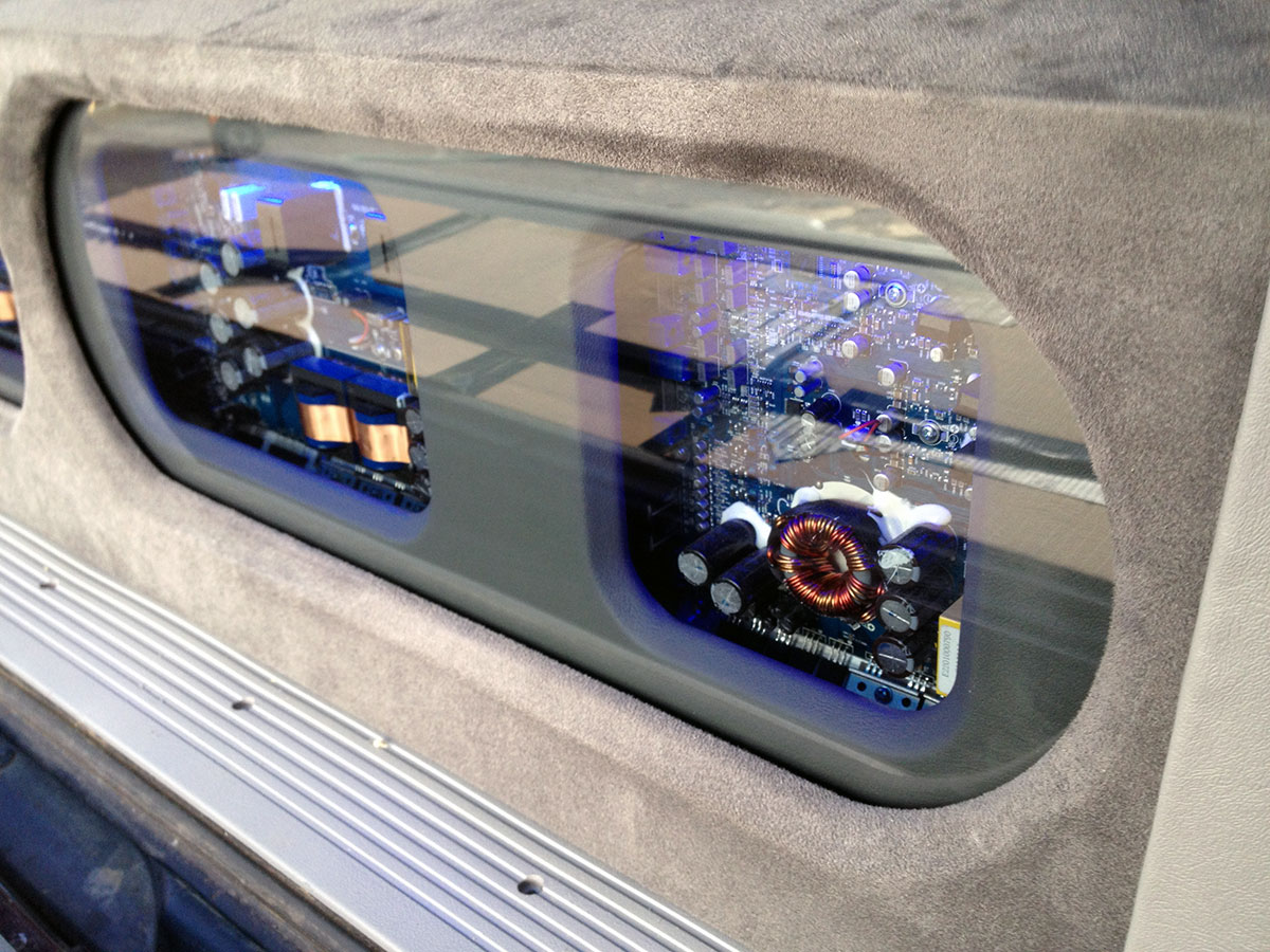 amplifier rack installation in SUV with electronics visible behind glass panel amplifier rack installation in SUV with electronics visible behind glass panel